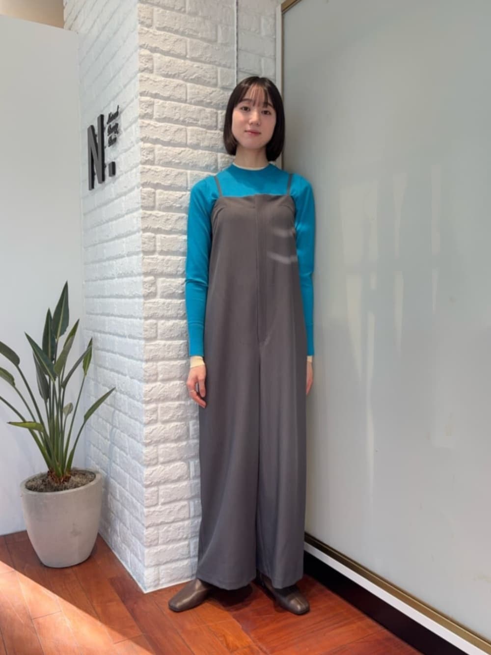 ブルー系のニット/セーター、グレー系のつなぎ/オールインワンを着用したレディースの冬コーディネートの1枚目の写真