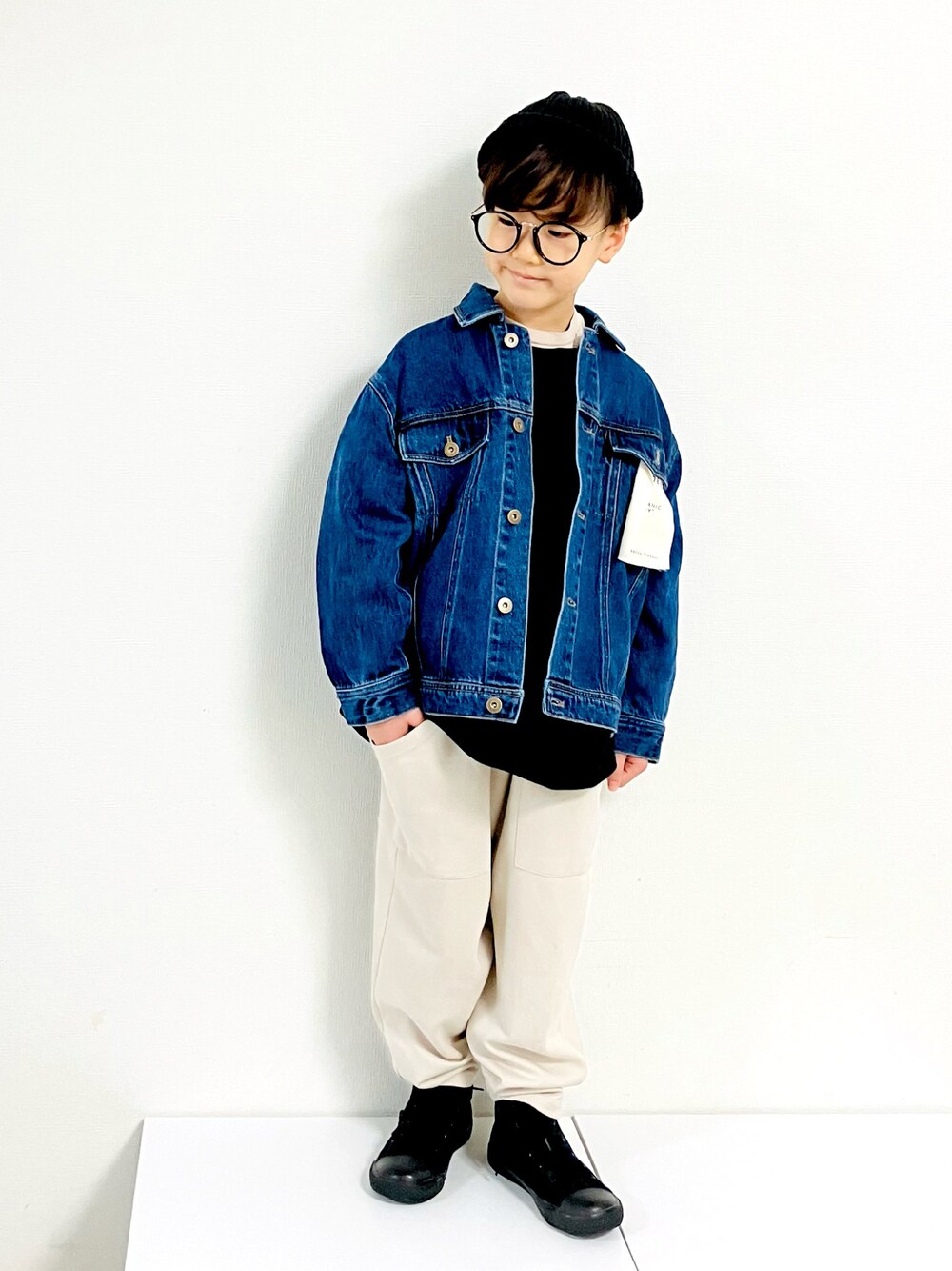 ブルー系のデニムジャケット、ホワイト系のその他パンツ、ブラック系のスニーカーを着用したキッズの秋コーディネートの1枚目の写真