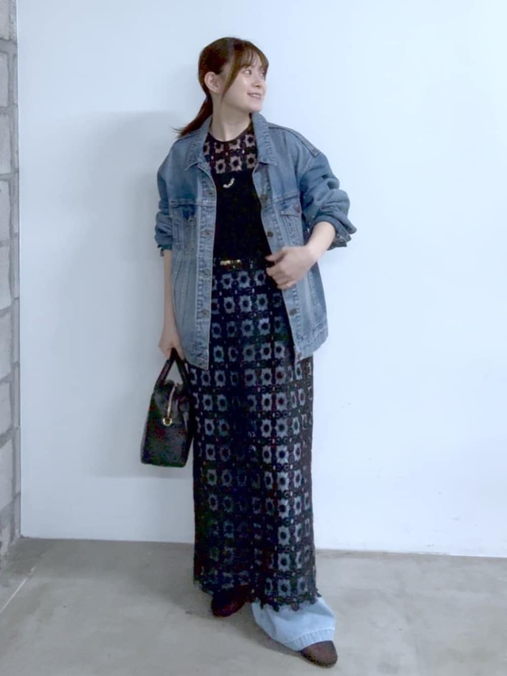 ブルー系のデニムジャケット、ブラック系のその他シューズ、ブラック系のボストンバッグを着用したレディースの冬コーディネートの1枚目の写真