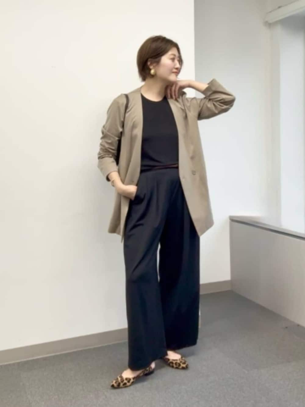 ベージュ系のパンプス、ブラック系のスラックス、ブラック系のキャミソールを着用したレディースの夏コーディネートの1枚目の写真