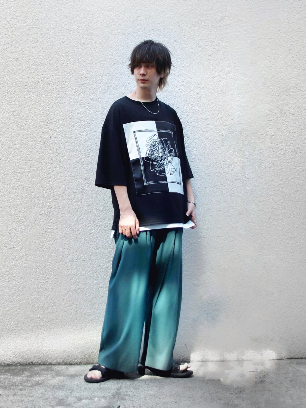 ブラック系のTシャツ/カットソー、グリーン系のスラックス、ホワイト系のタンクトップを着用したメンズの夏コーディネートの1枚目の写真