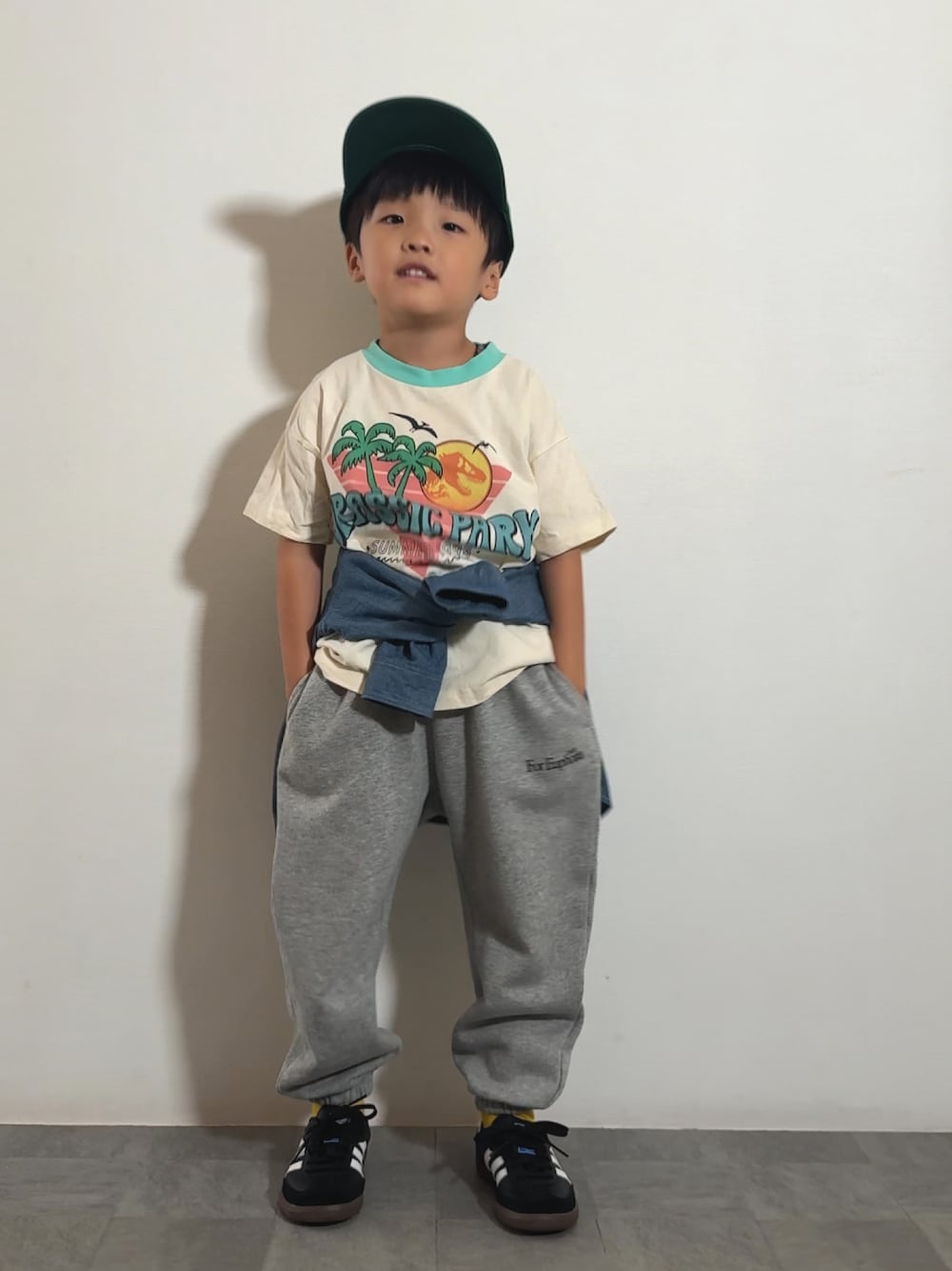 グレー系のスウェットパンツ、ブラック系のスニーカー、ホワイト系のTシャツ/カットソーを着用したキッズの秋コーディネートの1枚目の写真