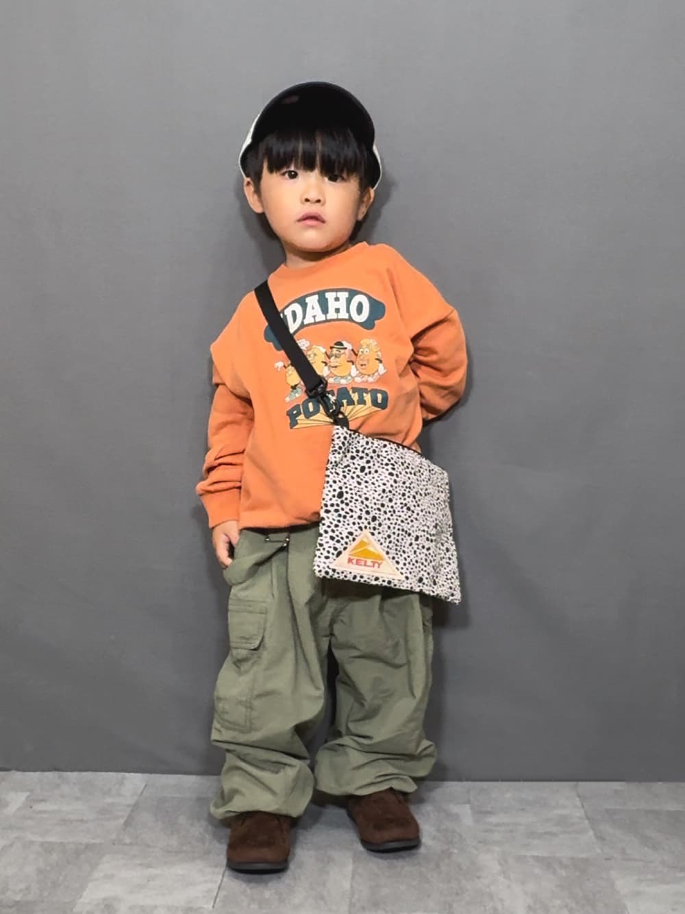 「秋っぽコーデ更新中、カーキ、ショルダーバッグ、サロペット、スウェット、キャップ、ブーツ、カーゴパンツ、お出かけコーデ、秋コーデ、パステルカラー、ブラウン、淡色コーデ、テーマパークコーデ、デートコーデ」｜「Ocean&Groundのアイテム（スウェット、オレンジ系）」を使った、YU⭐︎さん（キッズ・90cm）の秋コーディネートの1枚目の写真