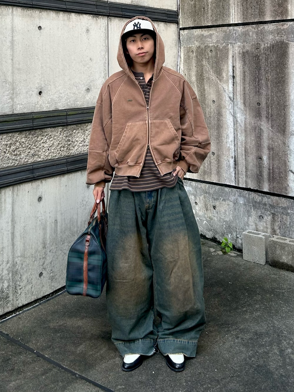 ブルー系のデニムパンツ、ブラック系のローファー、ブラウン系のパーカーを着用したメンズの秋コーディネートの1枚目の写真