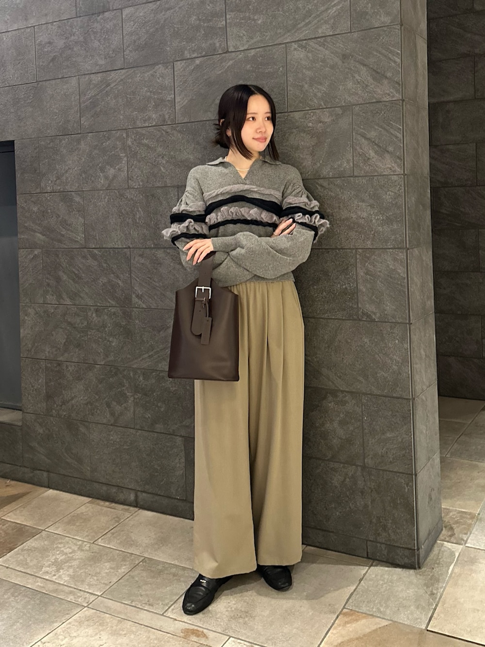 ブラウン系のショルダーバッグ、ベージュ系のその他パンツ、グレー系のニット/セーターを着用したレディースの秋コーディネートの1枚目の写真
