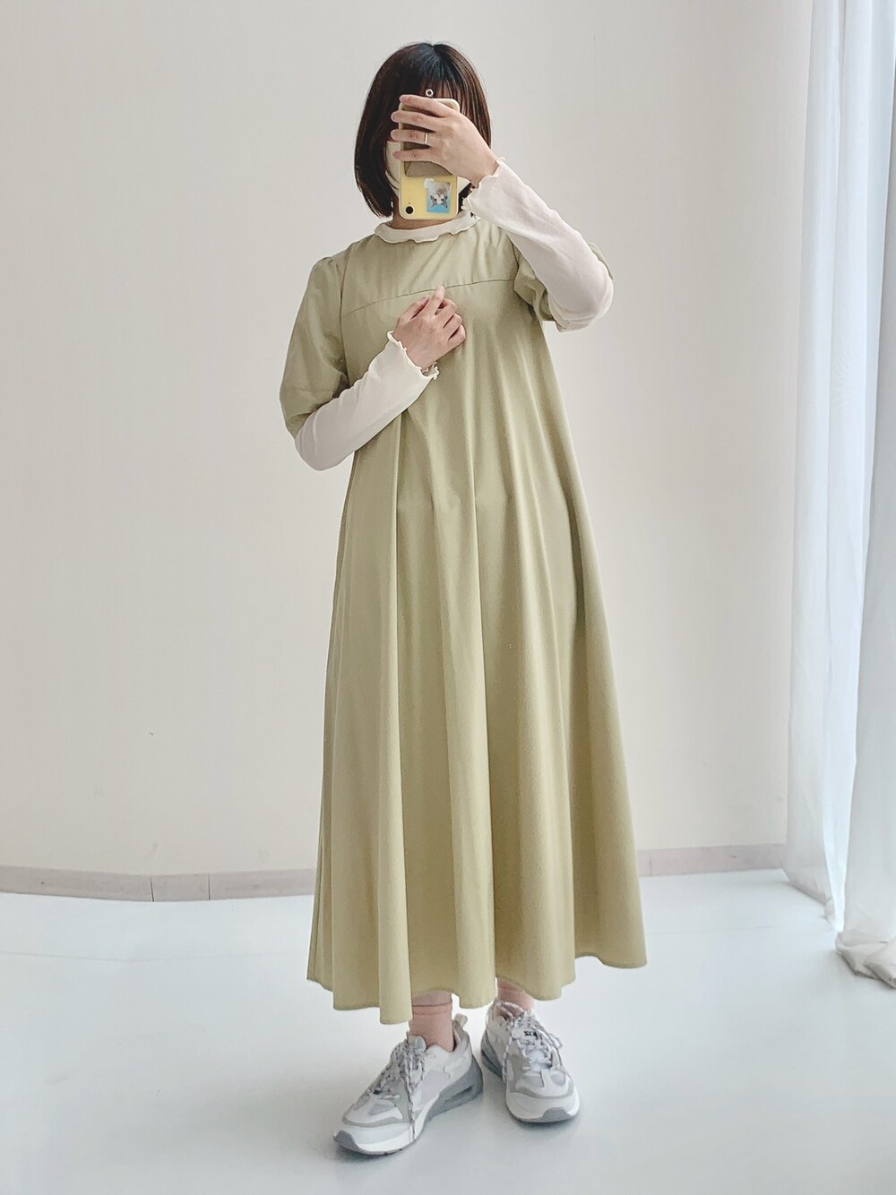 ホワイト系のTシャツ/カットソー、グリーン系のワンピース、グレー系のスニーカーを着用したレディースの春コーディネートの1枚目の写真