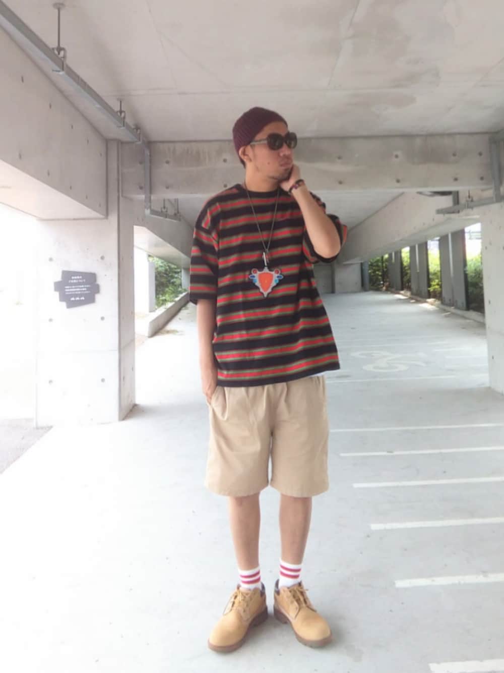 ブラック系のTシャツ/カットソー、ホワイト系のタンクトップ、ベージュ系のチノパンツを着用したメンズの夏コーディネートの1枚目の写真