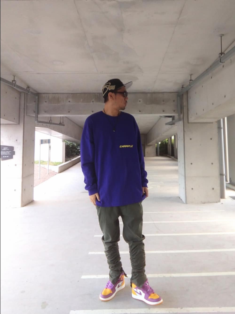 パープル系のTシャツ/カットソー、グリーン系のパンツ、イエロー系のスニーカーを着用したメンズの秋コーディネートの1枚目の写真