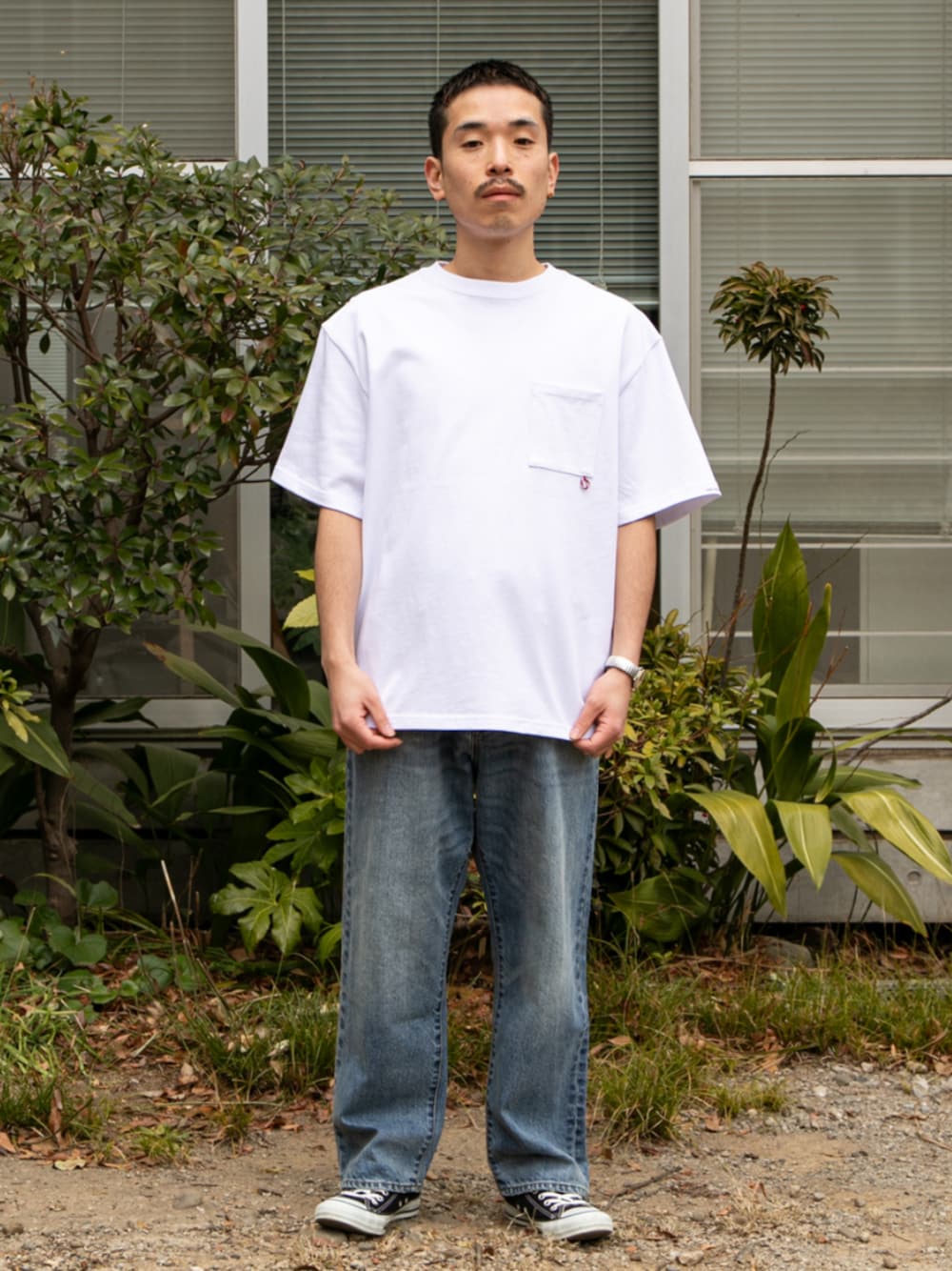 ブルー系のデニムパンツ、ホワイト系のTシャツ/カットソーを着用したメンズの春コーディネートの1枚目の写真