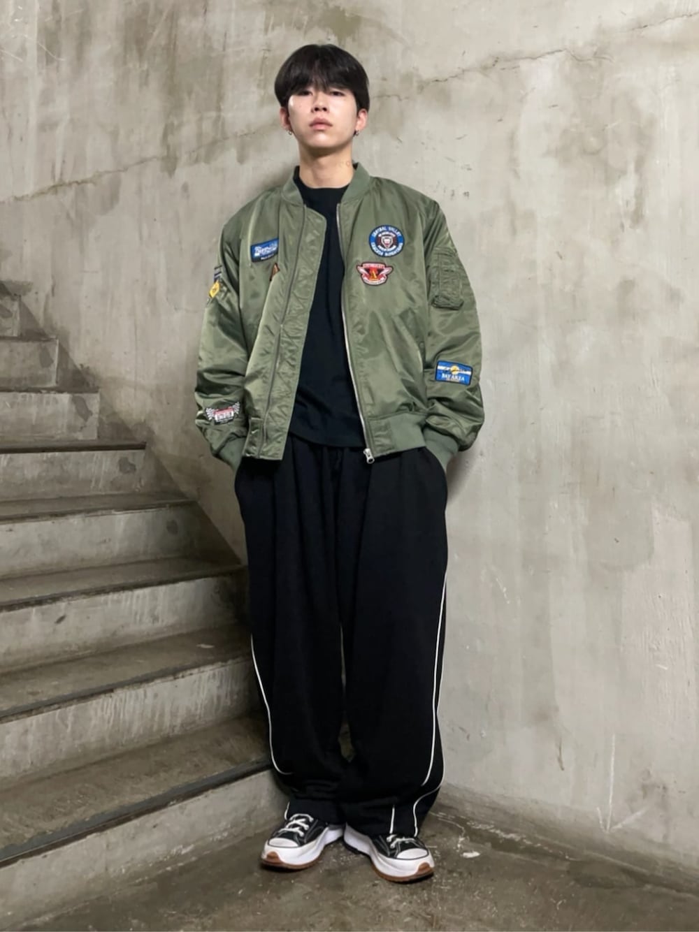 ブラック系のスウェットパンツ、ブラック系のTシャツ/カットソー、グリーン系のMA-1を着用したメンズの秋コーディネートの1枚目の写真