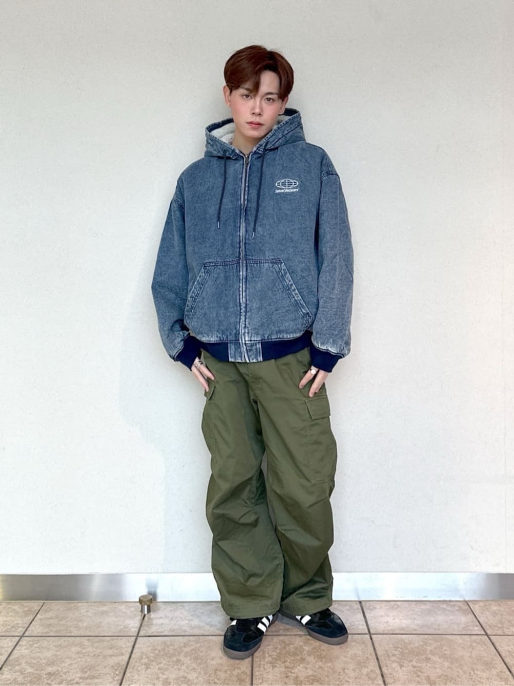 グリーン系のカーゴパンツ、ブルー系のブルゾンを着用したメンズの冬コーディネートの1枚目の写真