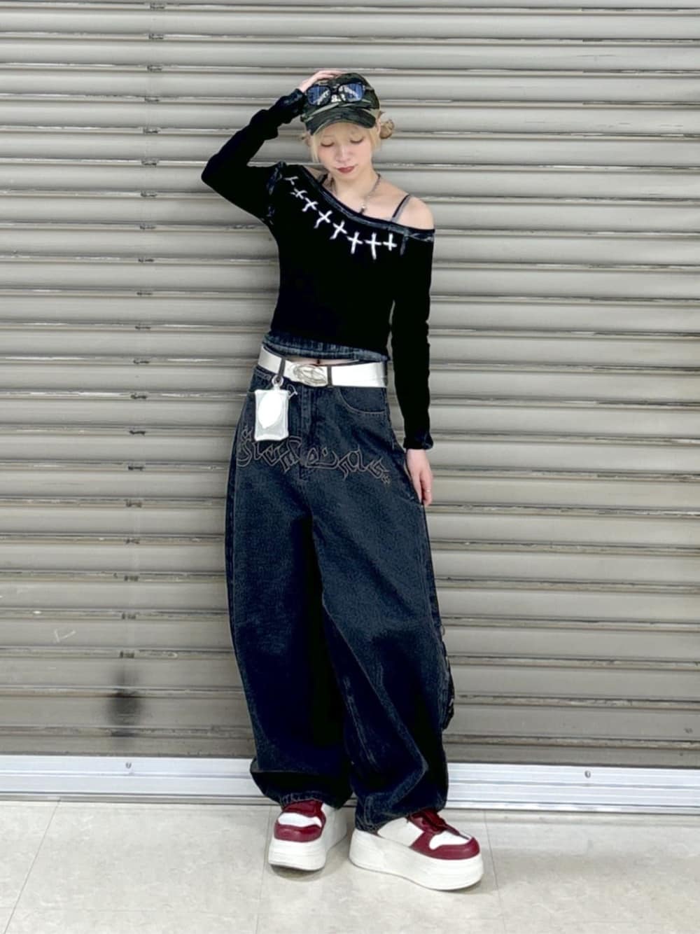 レッド系のスニーカー、ブラック系のデニムパンツ、グレー系のキャミソールを着用したレディースの春コーディネートの1枚目の写真