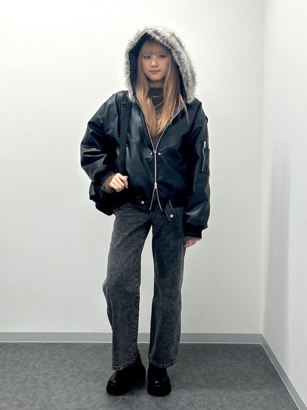 ブラック系のデニムパンツ、ブラック系のブルゾン、ブラック系のスニーカーを着用したレディースの春コーディネートの1枚目の写真