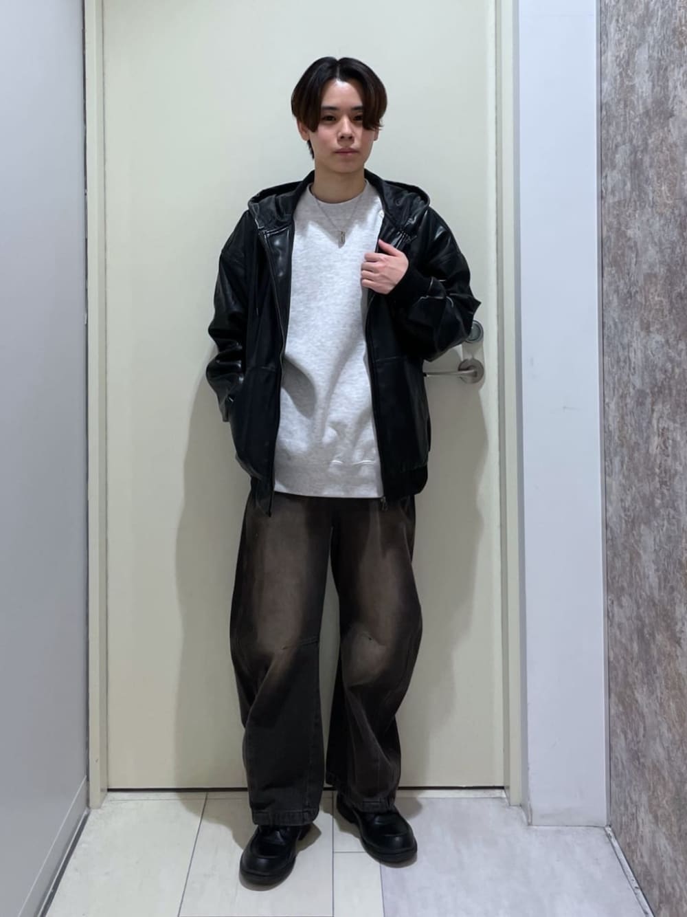 ブラック系のデニムパンツ、ブラック系のライダースジャケット、グレー系のスウェットを着用したメンズの冬コーディネートの1枚目の写真