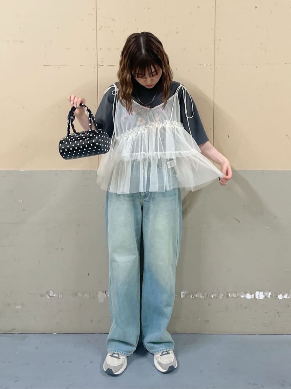 その他のTシャツ/カットソー、ブルー系のデニムパンツ、ブラック系のハンドバッグを着用したレディースの春コーディネートの1枚目の写真
