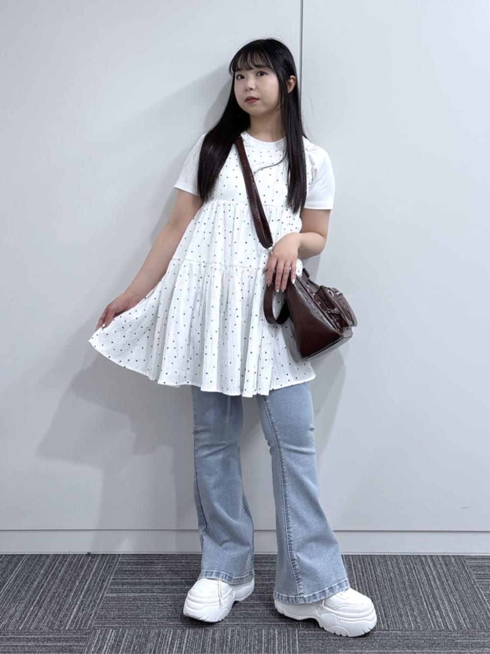 ブルー系のデニムパンツ、ホワイト系のスニーカー、ホワイト系のTシャツ/カットソーを着用したレディースの夏コーディネートの1枚目の写真