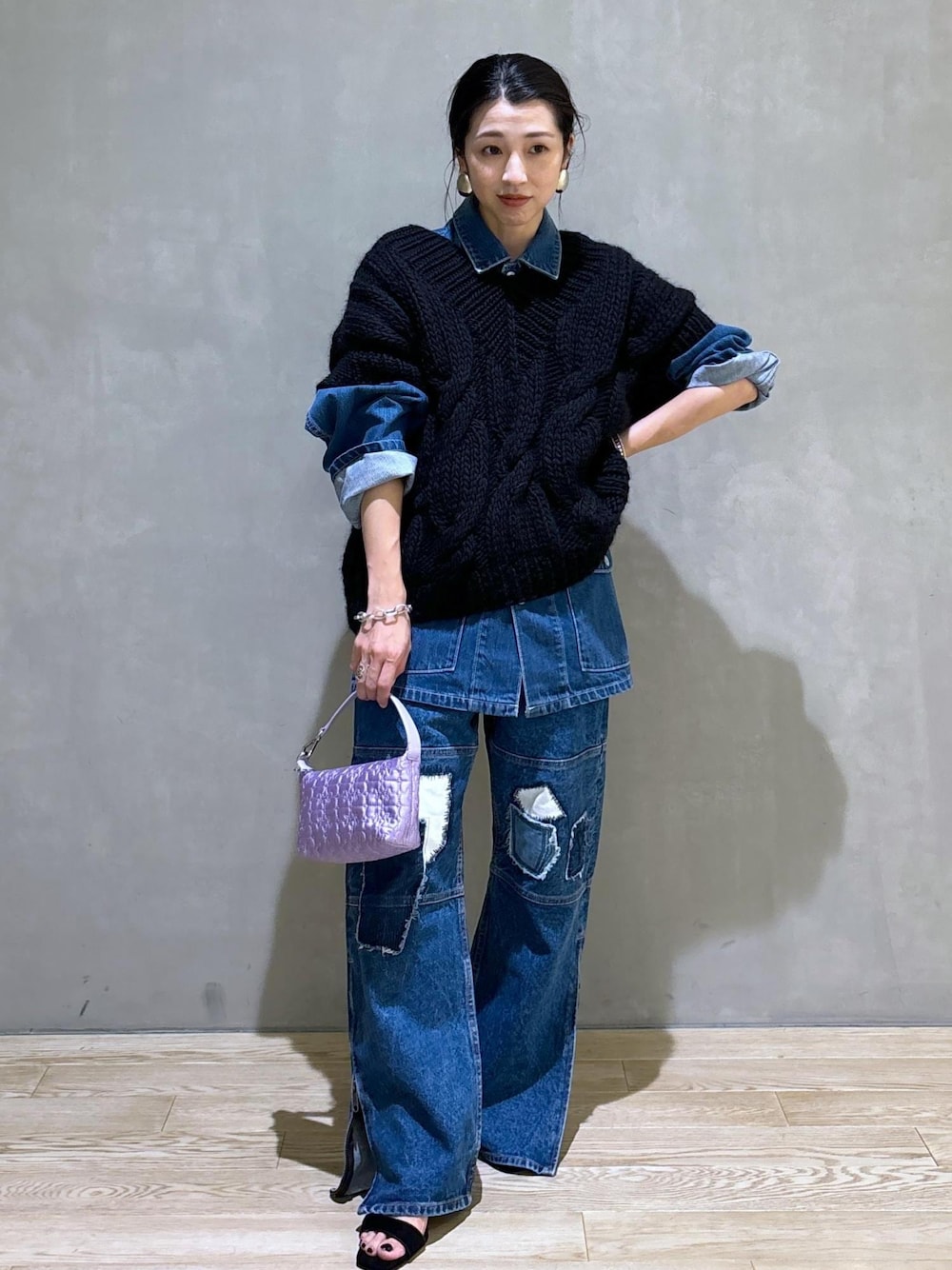 パープル系のハンドバッグ、ブルー系のカバーオール、ブルー系のデニムパンツを着用したレディースの夏コーディネートの1枚目の写真