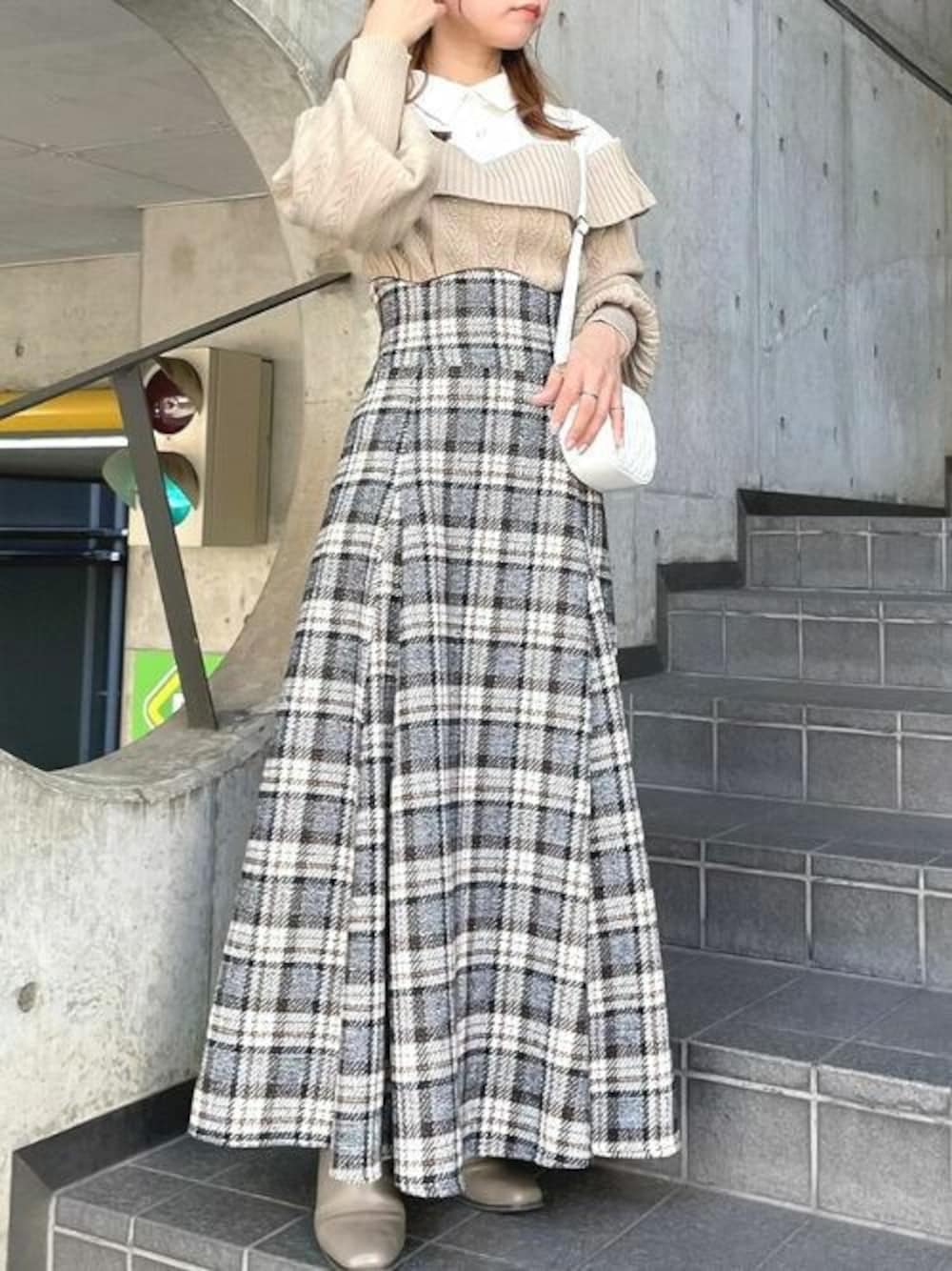 ベージュ系のニット/セーター、ブラウン系のスカートを着用したレディースの秋コーディネートの1枚目の写真