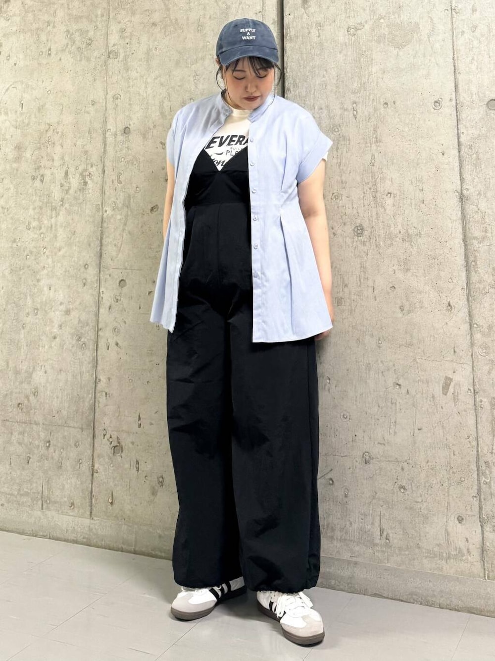 パープル系のシャツ/ブラウス、ブラック系のサロペット/オーバーオール、ブルー系のキャップを着用したレディースの夏コーディネートの1枚目の写真