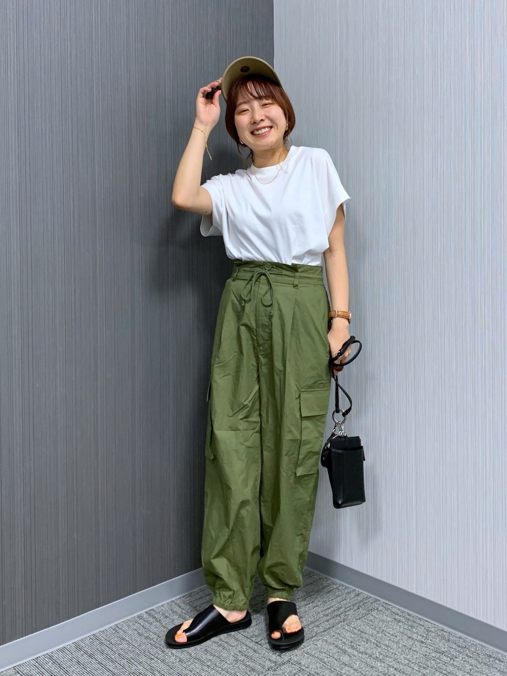 ホワイト系のTシャツ/カットソー、グリーン系のその他パンツ、ブラック系のバッグを着用したレディースの夏コーディネートの2枚目の写真