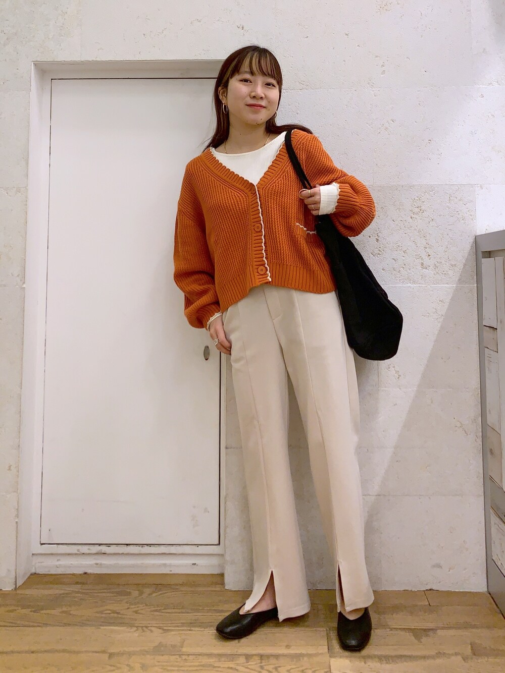 ブラウン系のトップス、ホワイト系のトップス、ホワイト系のパンツを着用したレディースの春コーディネートの1枚目の写真
