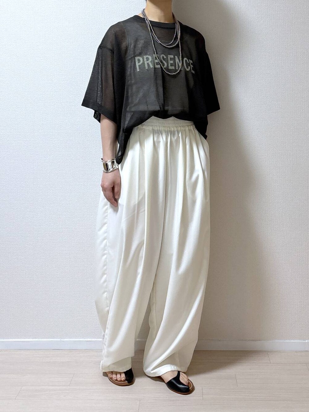 グレー系のニット/セーター、ホワイト系のその他パンツを着用したレディースの夏コーディネートの1枚目の写真