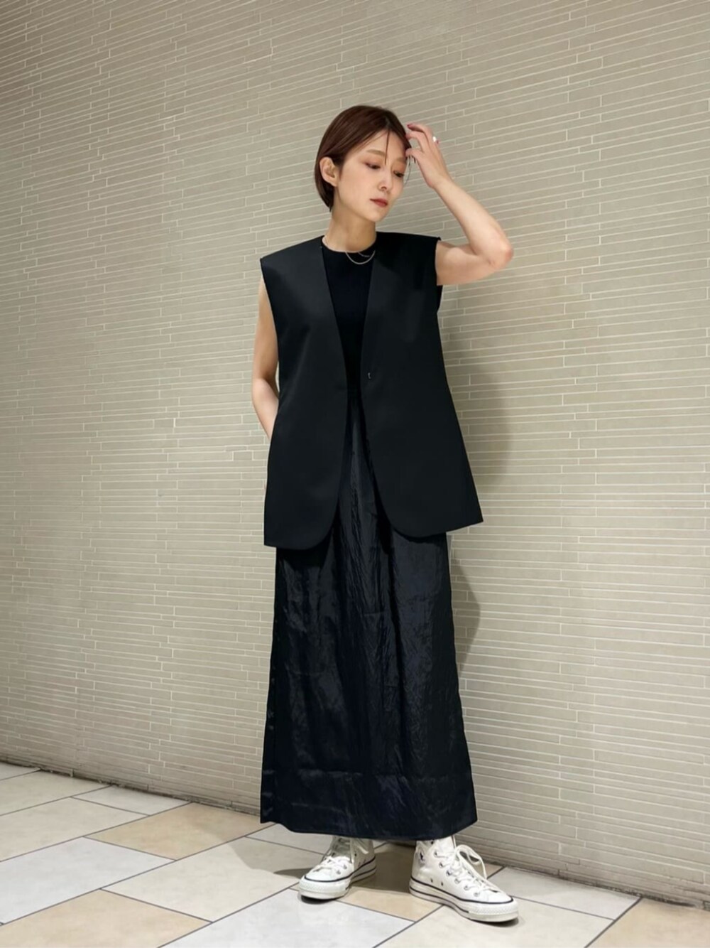 ホワイト系のスニーカーを着用したレディースの春コーディネートの1枚目の写真