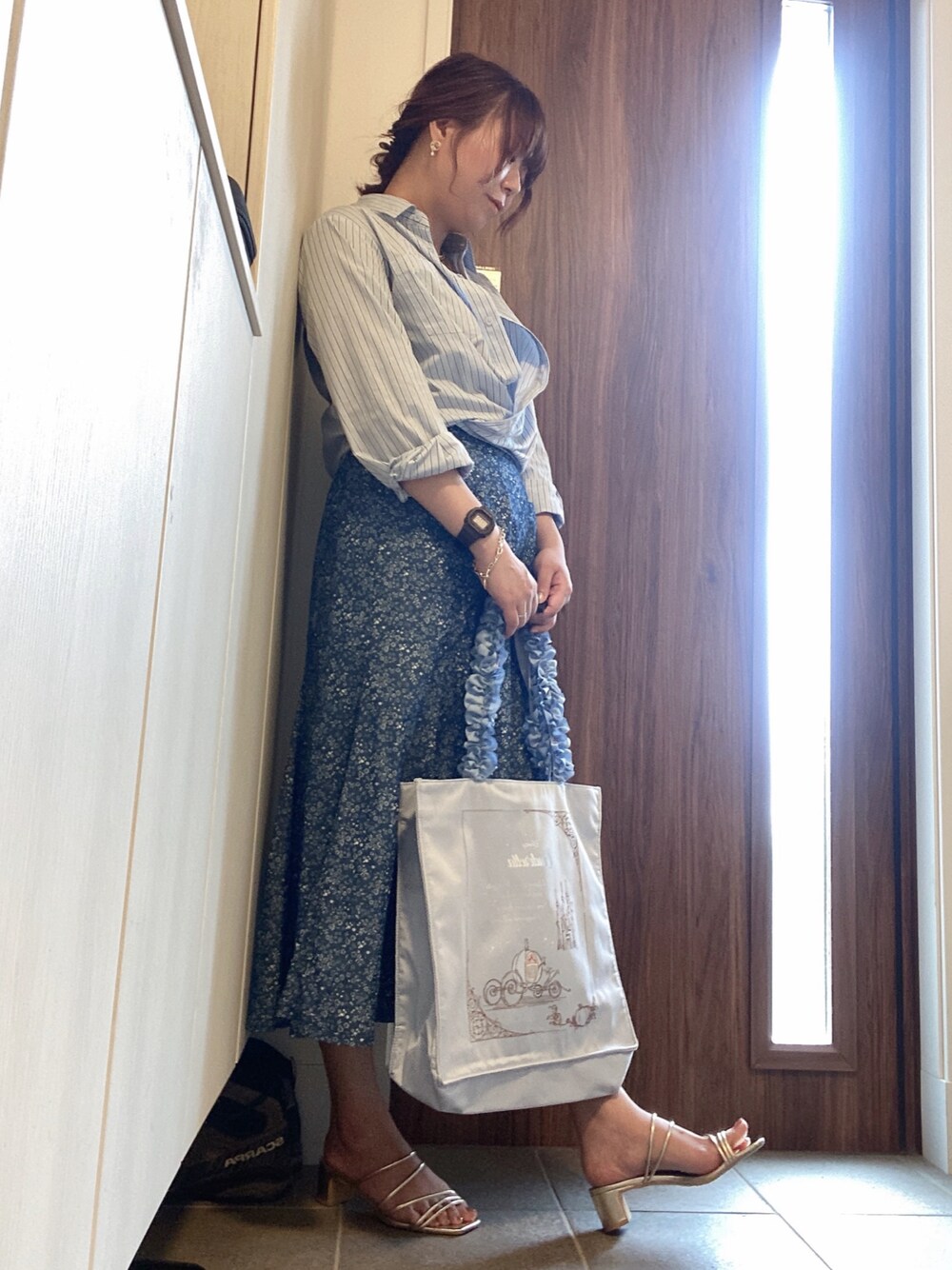 ブルー系のシャツ/ブラウス、ブラック系のキャミソール、ブルー系のデニムスカートを着用したレディースの春コーディネートの1枚目の写真