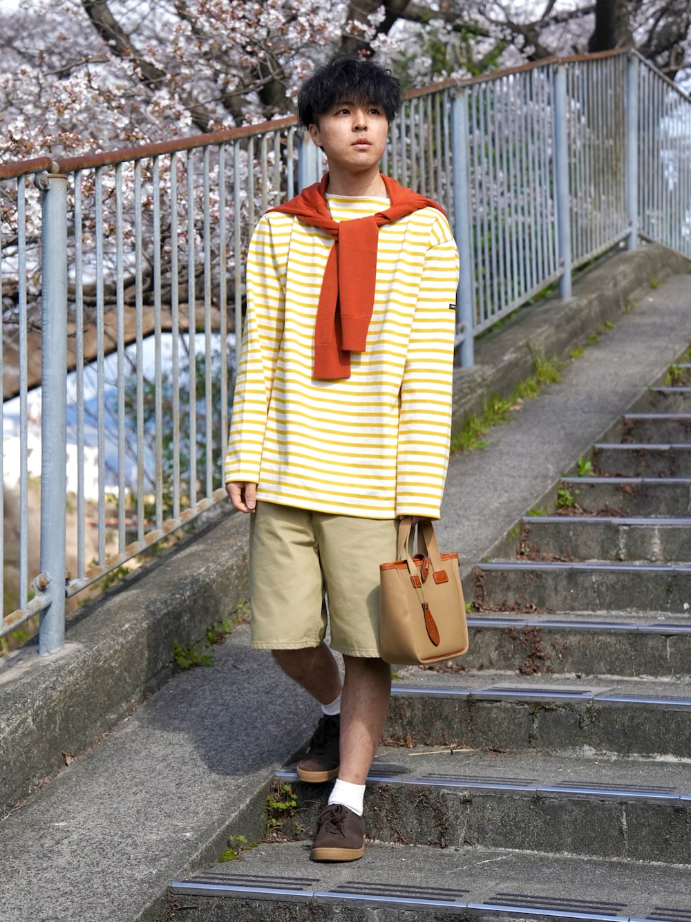 ベージュ系のその他パンツ、ブラウン系のスニーカー、ベージュ系のトートバッグを着用したメンズの春コーディネートの1枚目の写真