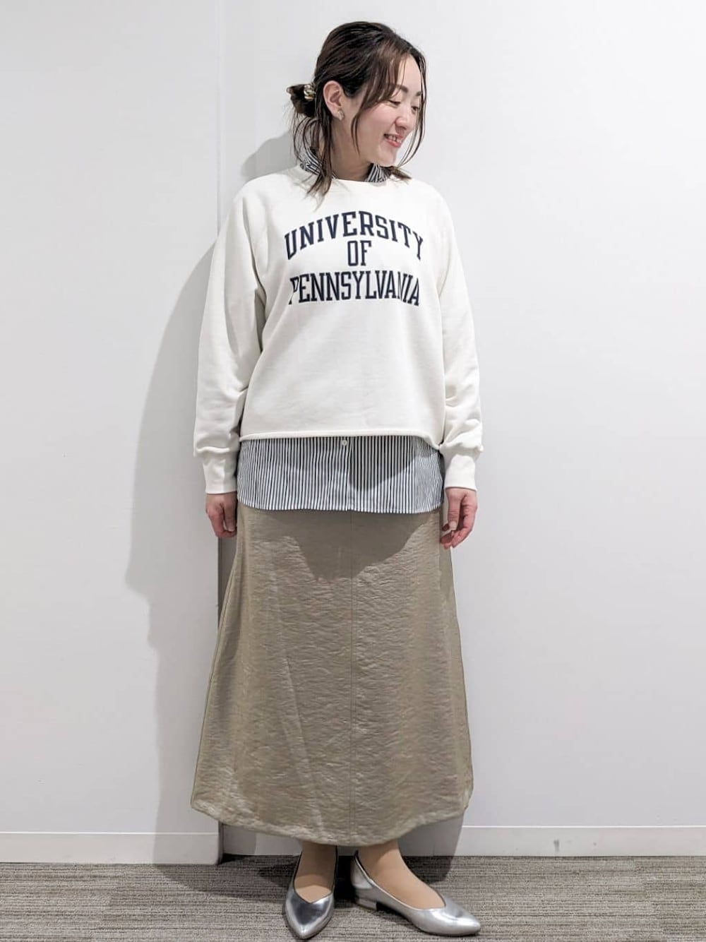 ホワイト系のスウェット、ホワイト系のシャツ/ブラウス、ベージュ系のスカートを着用したレディースの春コーディネートの1枚目の写真