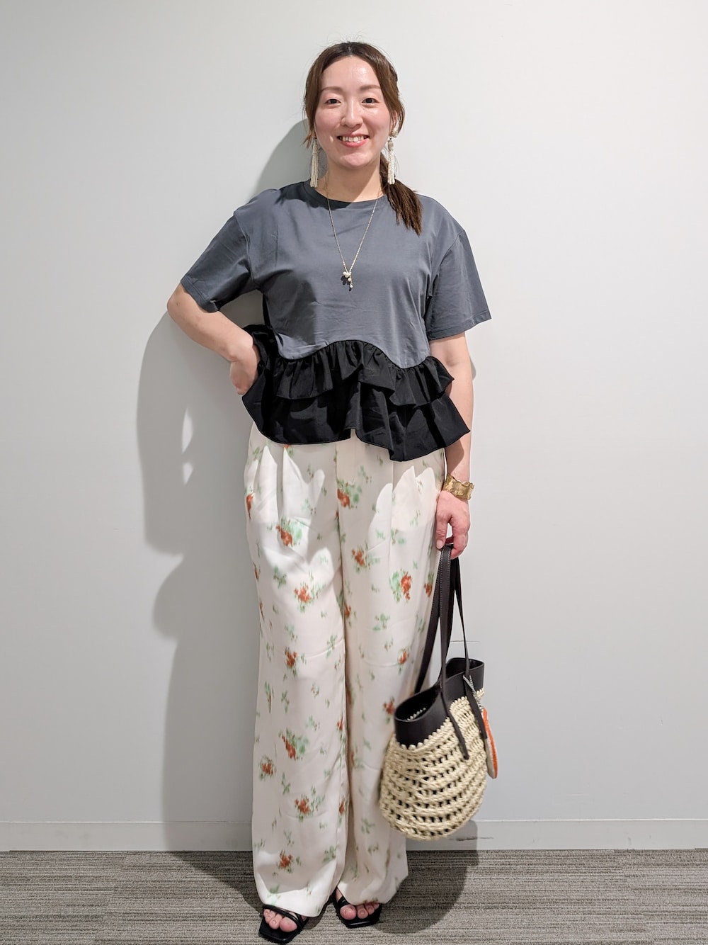 グレー系のTシャツ/カットソー、ホワイト系のその他パンツ、ブラウン系のトートバッグを着用したレディースの夏コーディネートの1枚目の写真