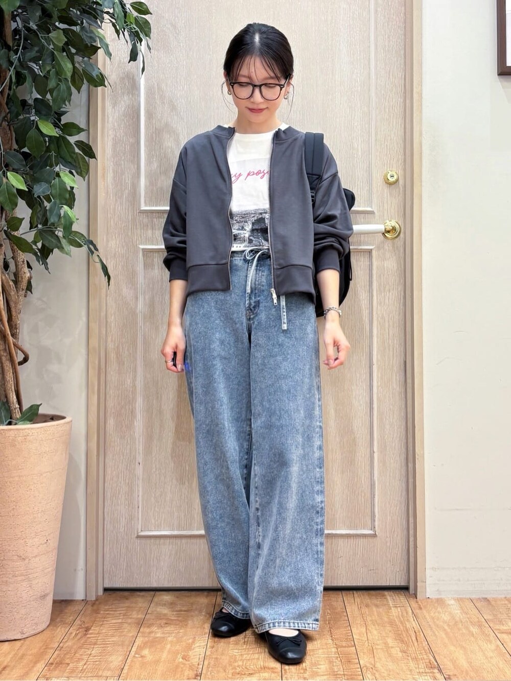 グレー系のカーディガン/ボレロ、ホワイト系のTシャツ/カットソー、ブルー系のデニムパンツを着用したレディースの秋コーディネートの1枚目の写真