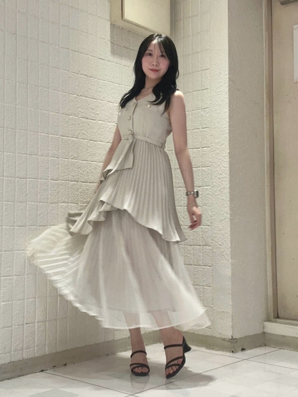 ベージュ系のワンピース、ブラック系のサンダルを着用したレディースの夏コーディネートの1枚目の写真
