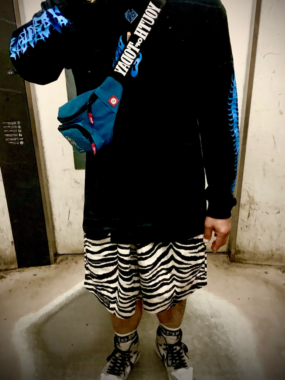 ホワイト系のパンツ、ホワイト系のスニーカー、ブラック系のTシャツ/カットソーを着用したメンズの夏コーディネートの1枚目の写真