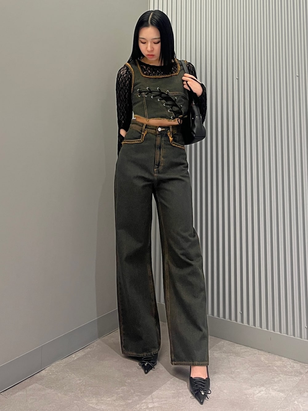 ブルー系のデニムパンツ、ブルー系のタンクトップ、ブラック系のTシャツ/カットソーを着用したレディースの春コーディネートの1枚目の写真