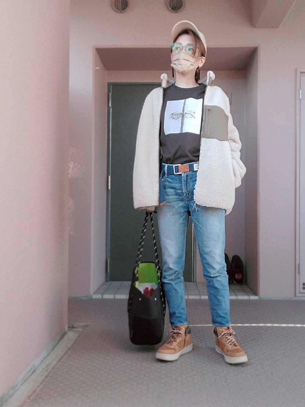 ブルー系のデニムパンツ、ブラック系のトートバッグ、イエロー系のスニーカーを着用したレディースの秋コーディネートの1枚目の写真