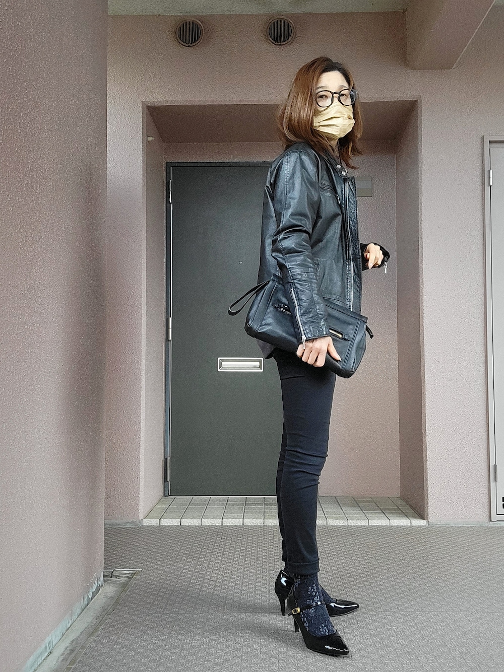 ブラック系のその他パンツ、ブラック系のクラッチバッグ、ブラック系のパンプスを着用したレディースの冬コーディネートの2枚目の写真