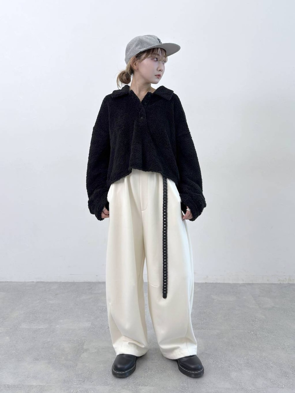 ベージュ系のその他パンツ、ブラック系のポロシャツ、グレー系のキャップを着用したレディースの秋コーディネートの1枚目の写真