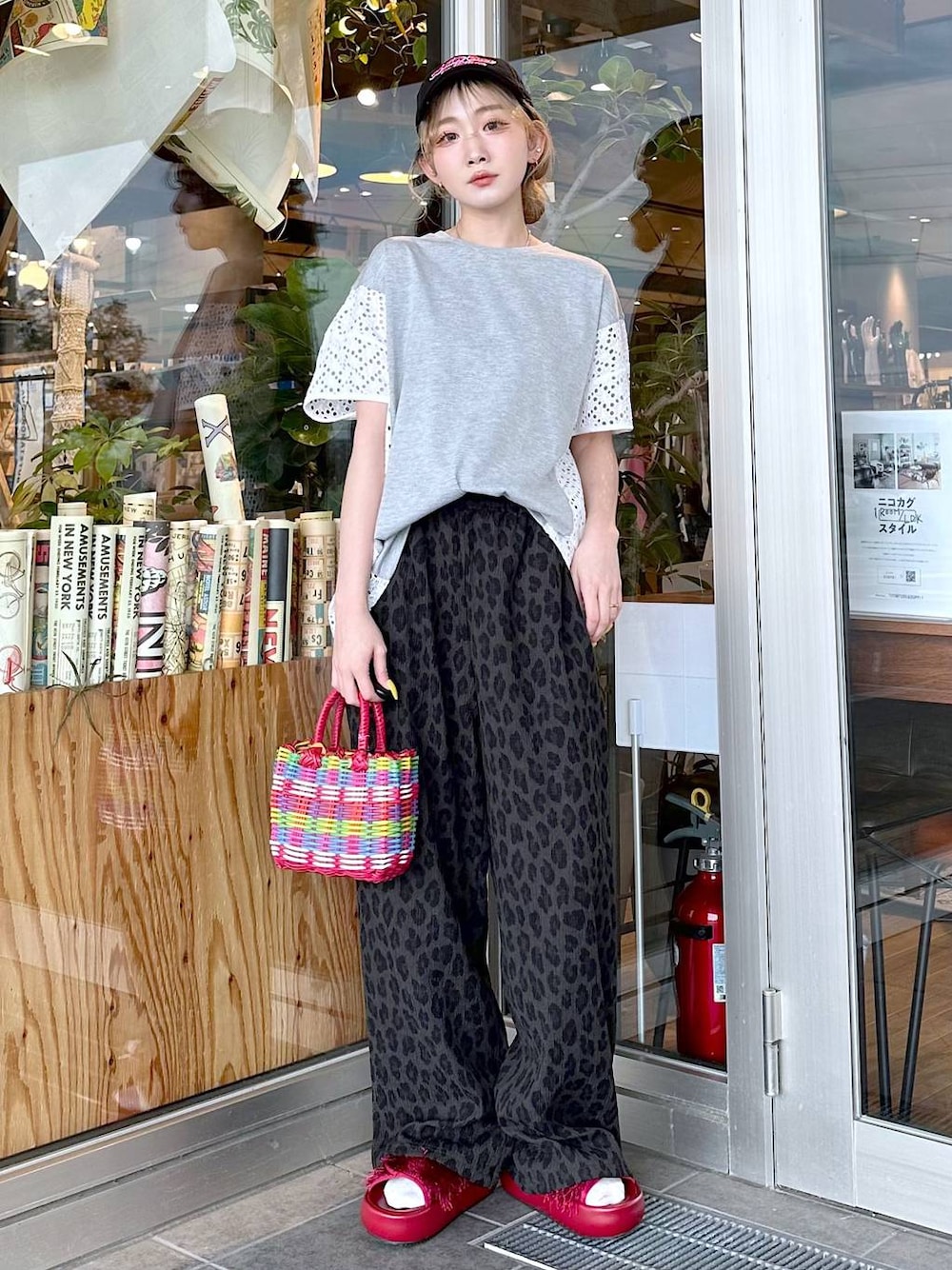 グレー系のその他パンツ、レッド系のサンダル、レッド系のハンドバッグを着用したレディースの春コーディネートの1枚目の写真