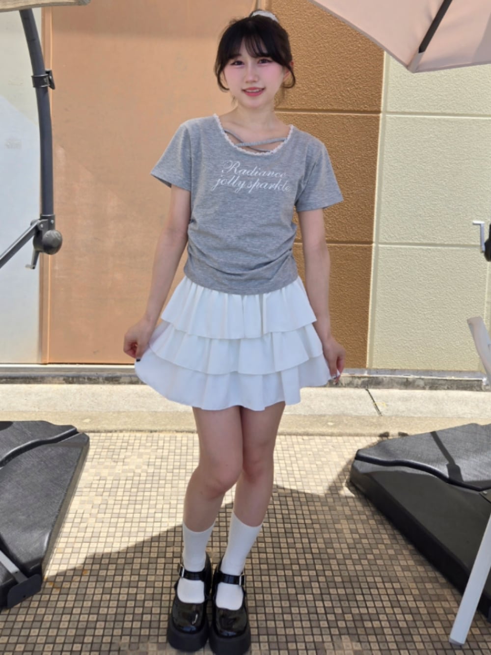 グレー系のTシャツ/カットソー、ホワイト系のスカートを着用したレディースの夏コーディネートの1枚目の写真