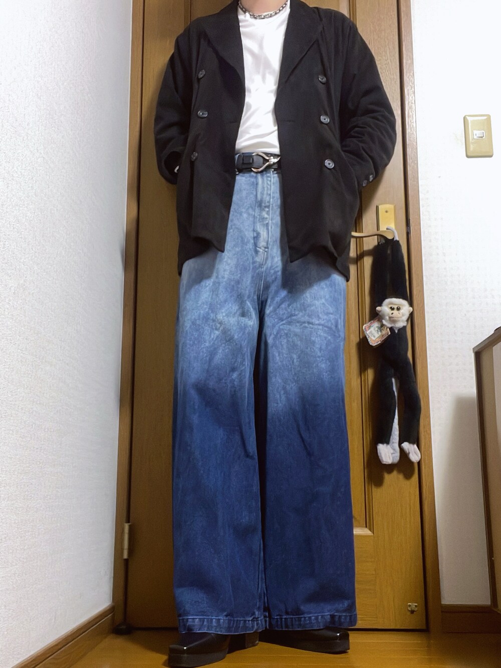 ブラック系のテーラードジャケット、ホワイト系のTシャツ/カットソー、ブルー系のデニムパンツを着用したメンズの秋コーディネートの1枚目の写真