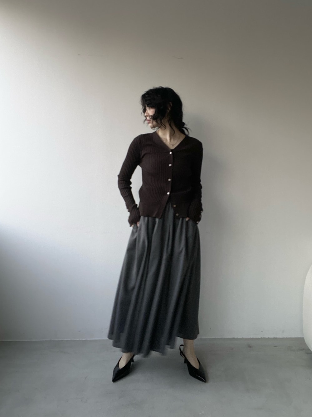 グレー系のスカートを着用したレディースの春コーディネートの1枚目の写真