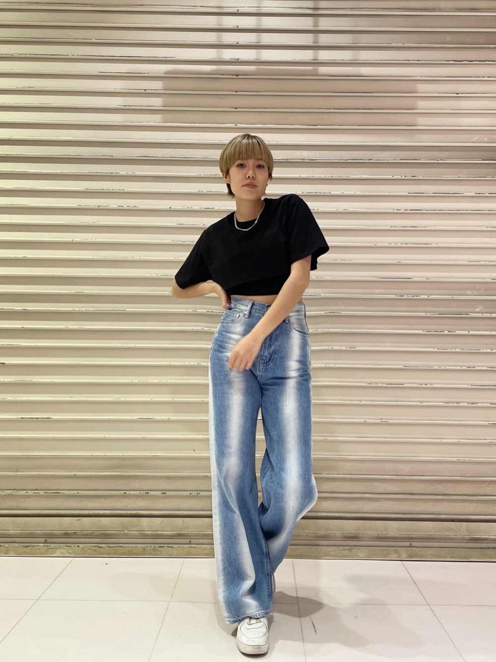 ブルー系のデニムパンツ、ブラック系のTシャツ/カットソー、シルバー系のネックレスを着用したレディースの春コーディネートの1枚目の写真