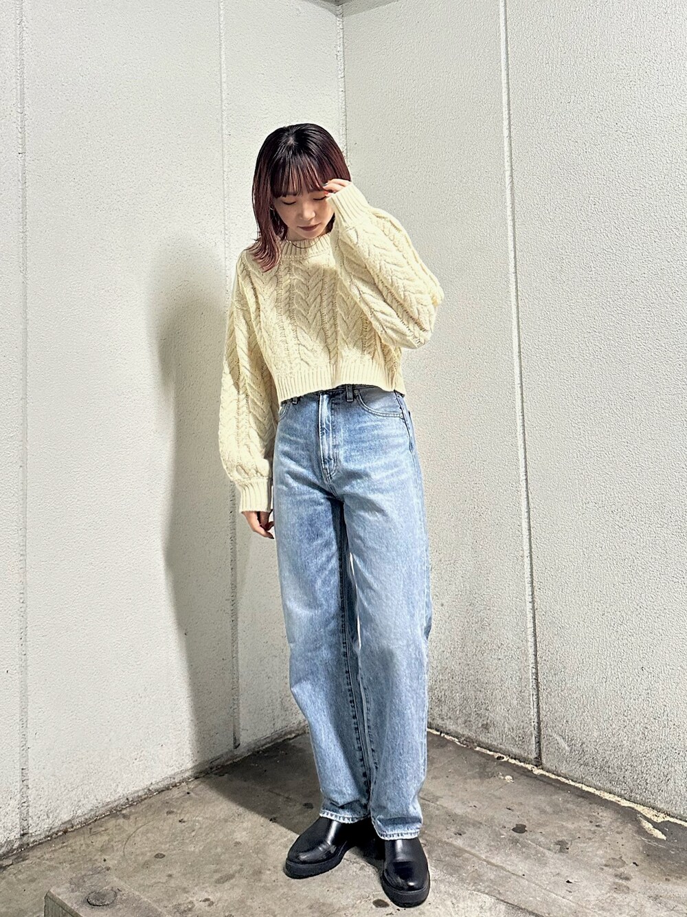 ホワイト系のニット/セーター、ブルー系のデニムパンツを着用したレディースの冬コーディネートの1枚目の写真