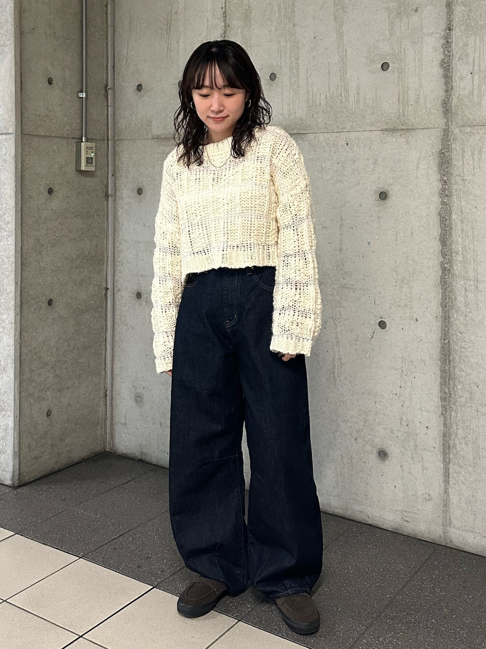 ベージュ系のニット/セーター、ブルー系のデニムパンツを着用したレディースの冬コーディネートの1枚目の写真