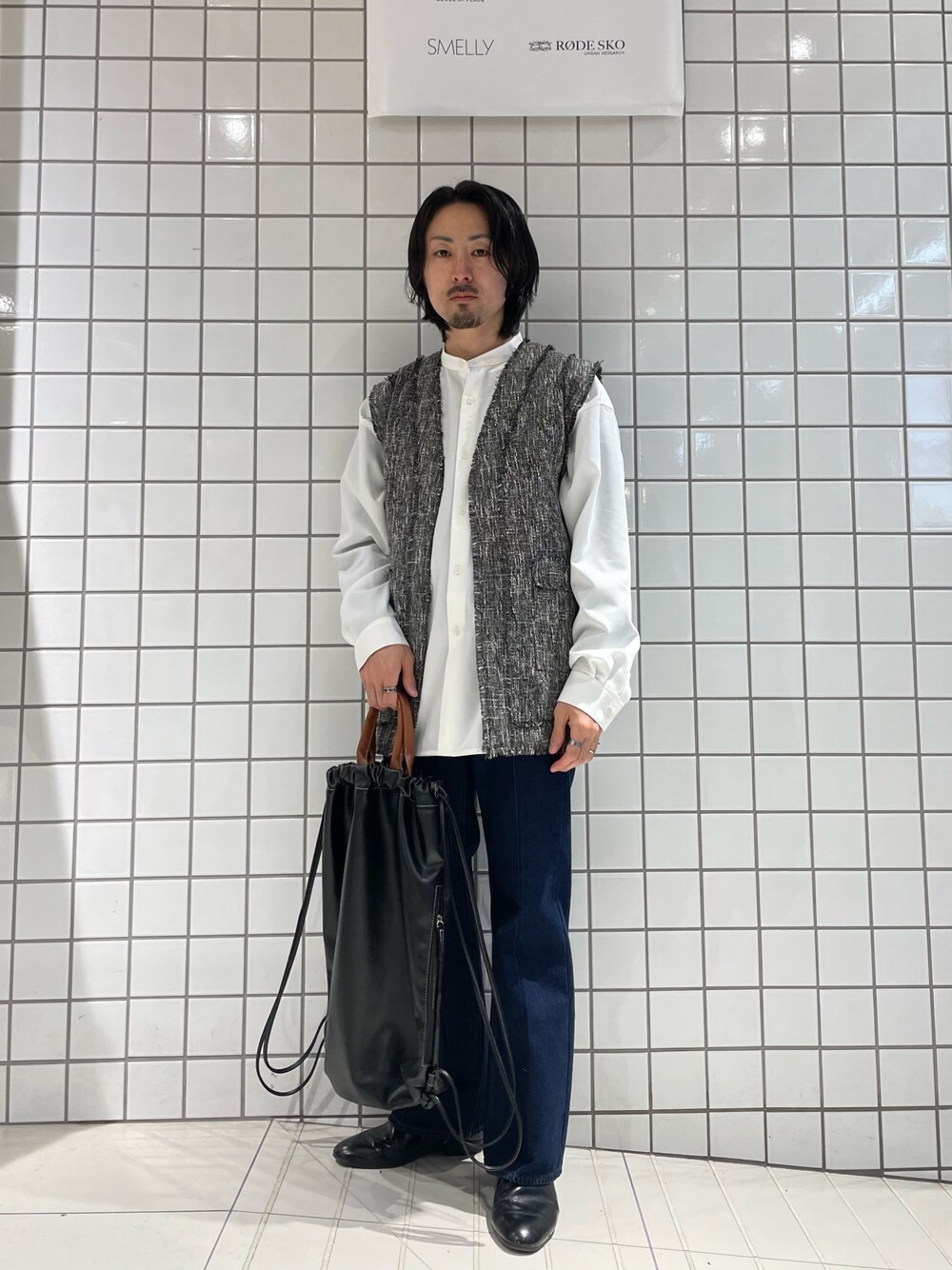 ブルー系のデニムパンツ、ブラック系のバックパック/リュック、ホワイト系のシャツ/ブラウスを着用したメンズの春コーディネートの1枚目の写真