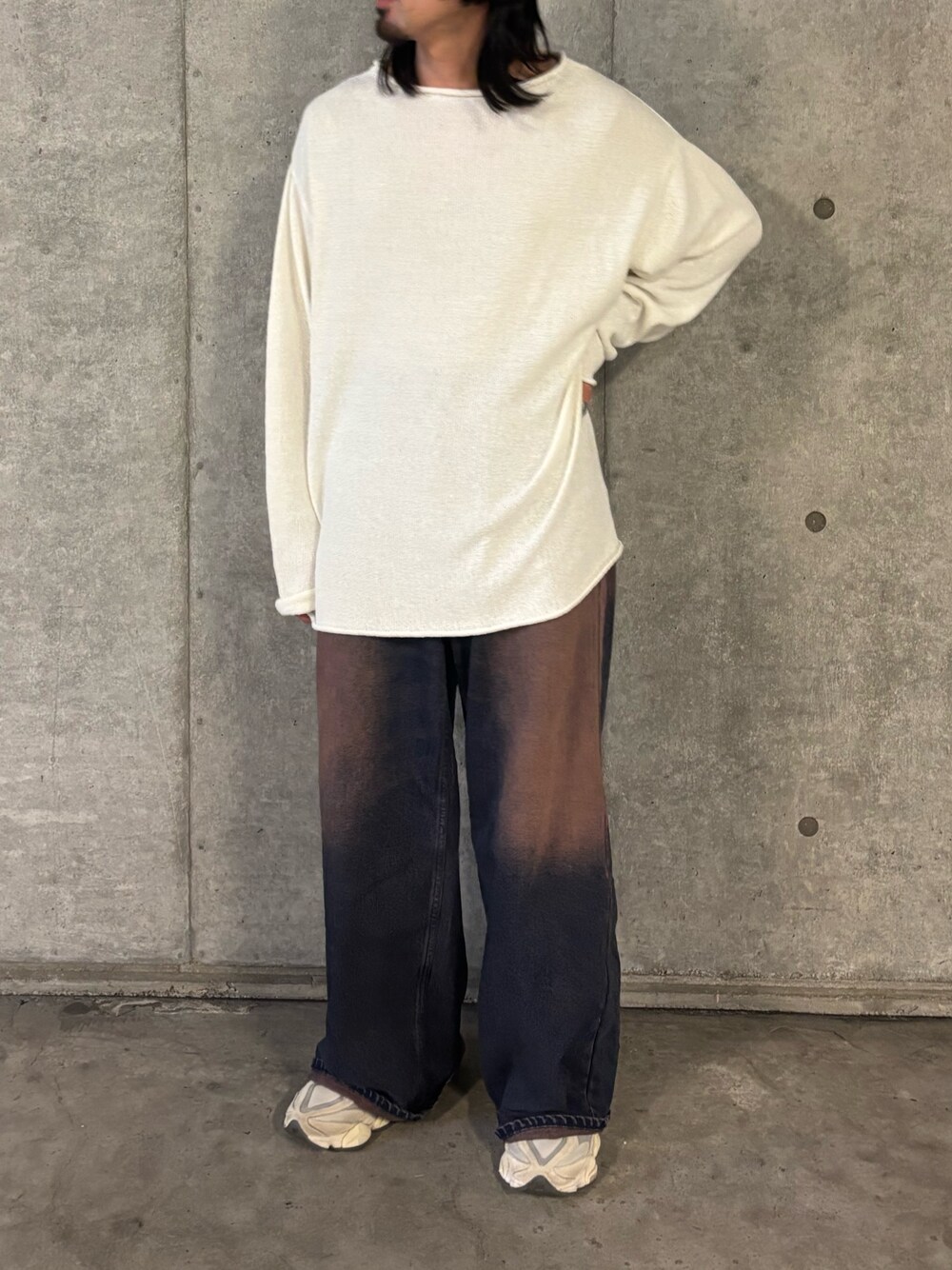 ホワイト系のニット/セーター、ブルー系のデニムパンツを着用したメンズの秋コーディネートの1枚目の写真