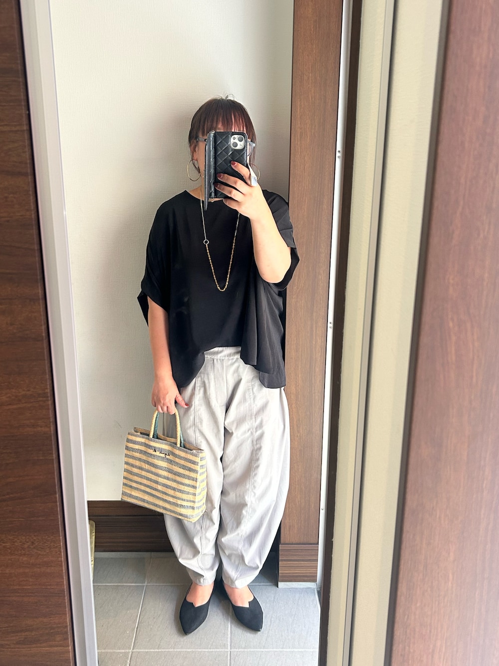 ブラック系のTシャツ/カットソー、グレー系のパンツ、ブラック系のパンプスを着用したレディースの夏コーディネートの1枚目の写真