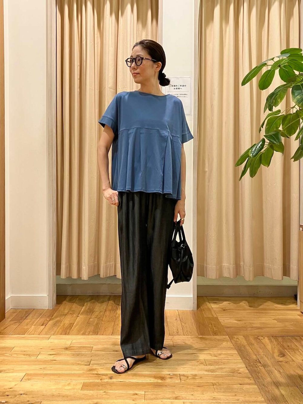 ブラック系のショルダーバッグ、ブラック系のデニムパンツ、ブルー系のTシャツ/カットソーを着用したレディースの夏コーディネートの1枚目の写真