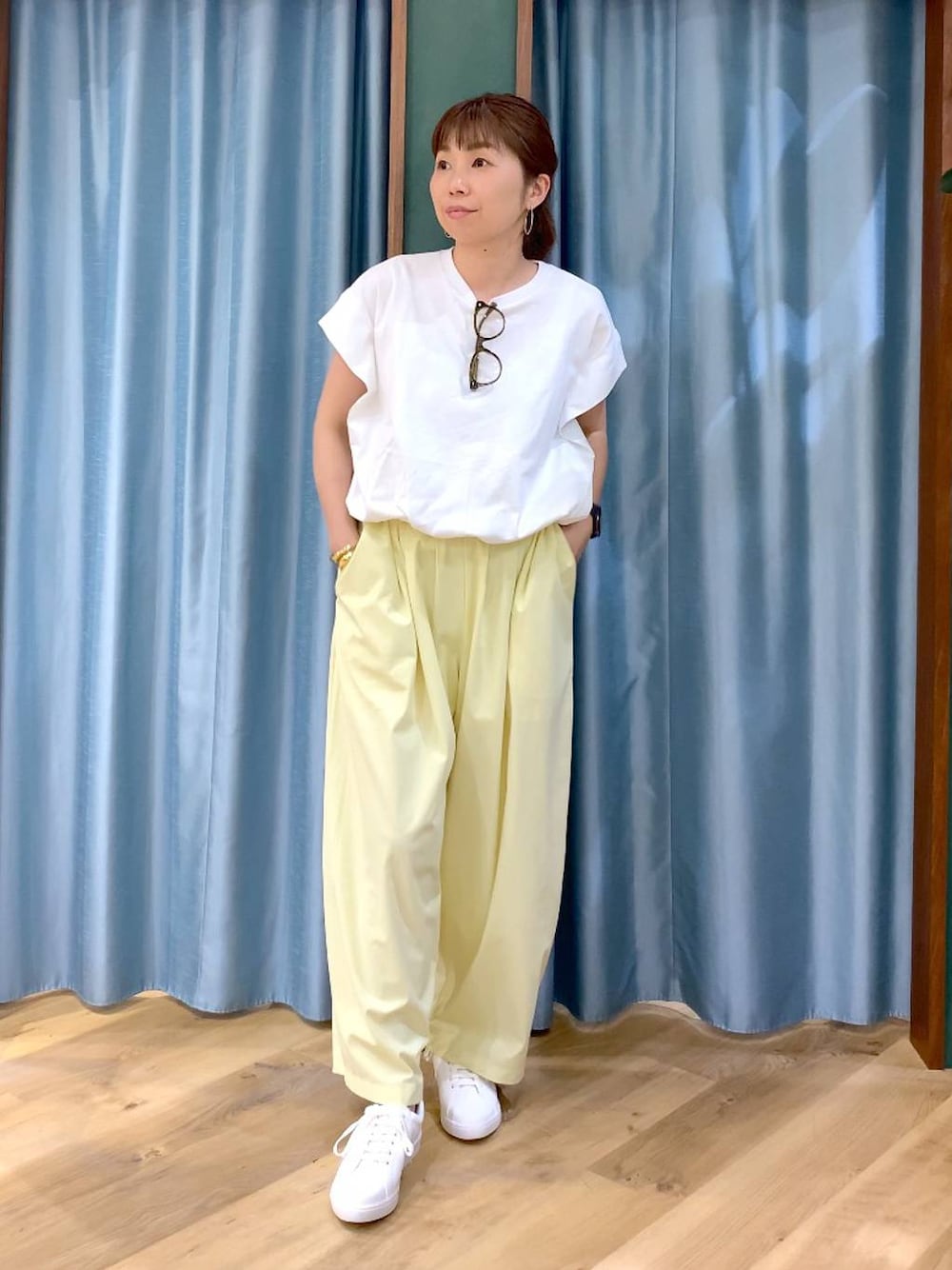ホワイト系のTシャツ/カットソー、イエロー系のその他パンツ、ホワイト系のスニーカーを着用したレディースの春コーディネートの1枚目の写真